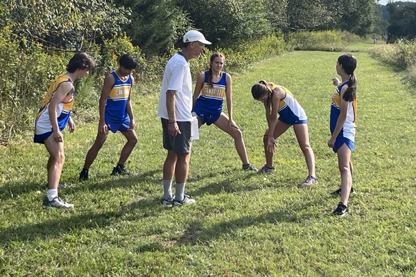 Coach Smith warming runners up before a meet.